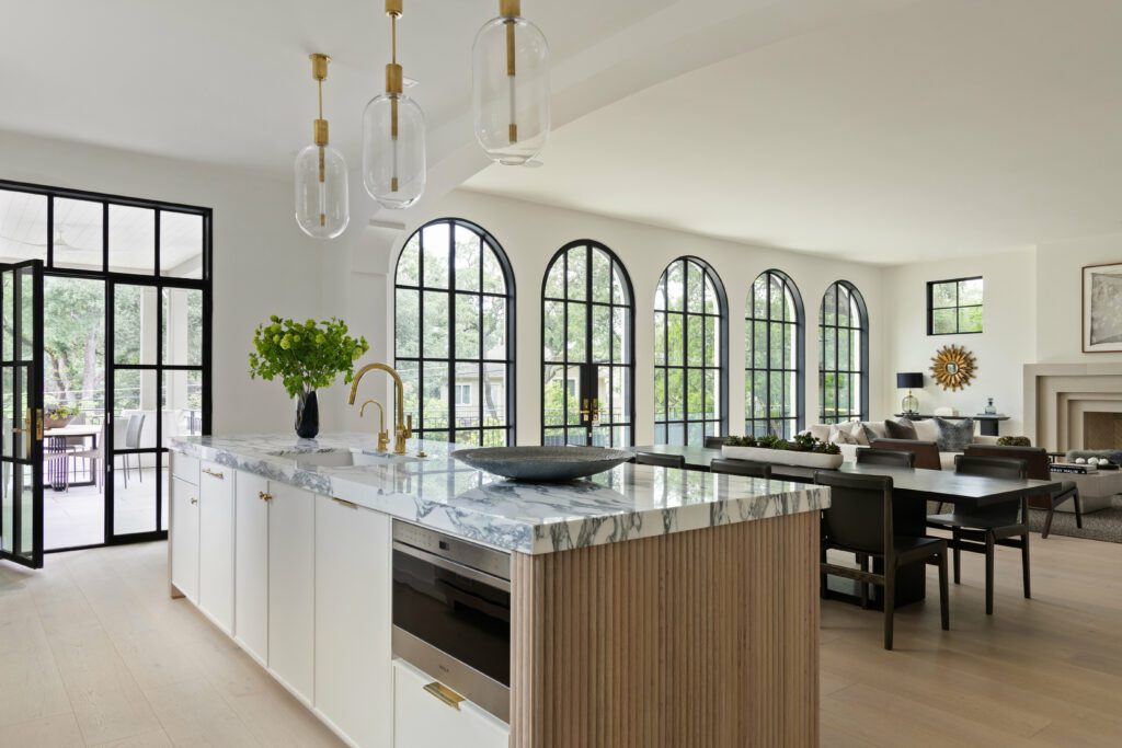Home by Sendero Homes · post-construction clean by clean+ Bright kitchen and dining room with arched windows in an Austin home cleaned by clean+